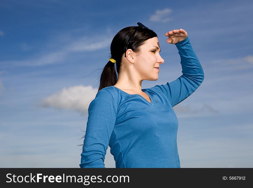 Attractive brunette woman relaxing on sky background. Attractive brunette woman relaxing on sky background