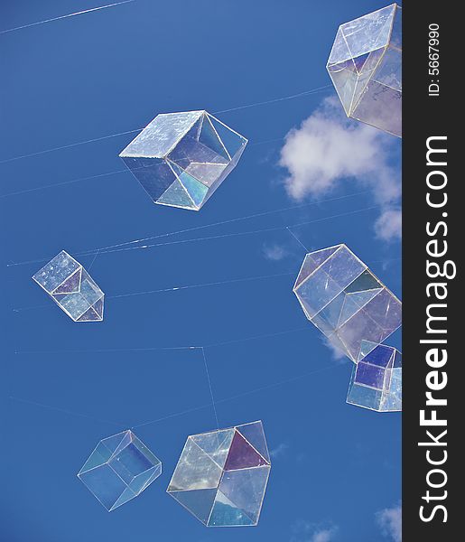 Installation art piece with floating perspex houses suspended on wire to look like polygonal soap bubbles, against vivid blue sky. Installation art piece with floating perspex houses suspended on wire to look like polygonal soap bubbles, against vivid blue sky