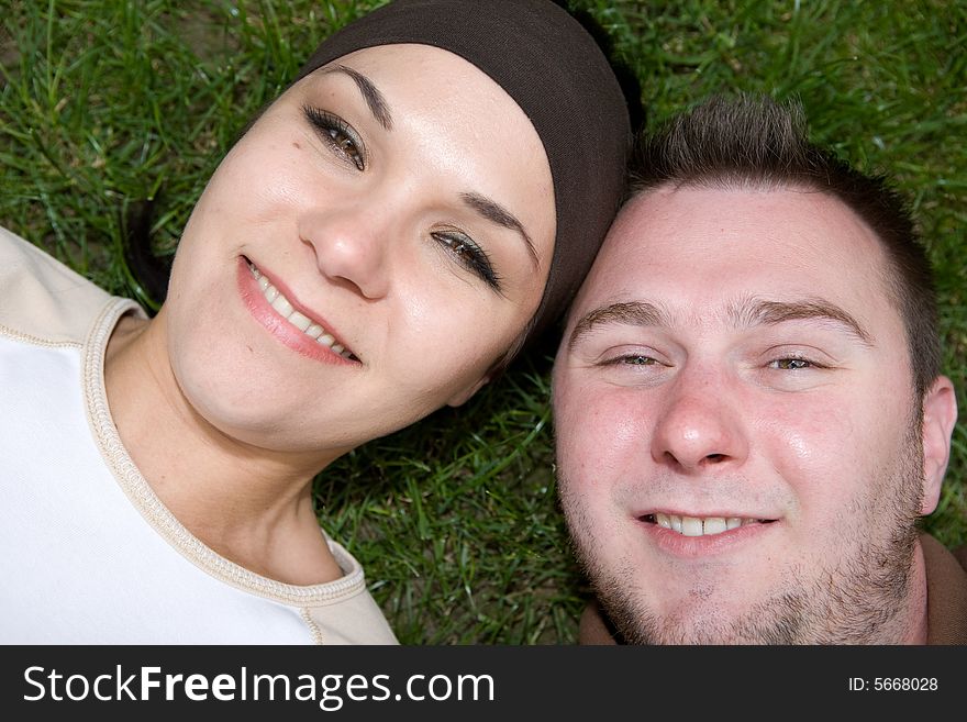 Happy friends relaxing on grass