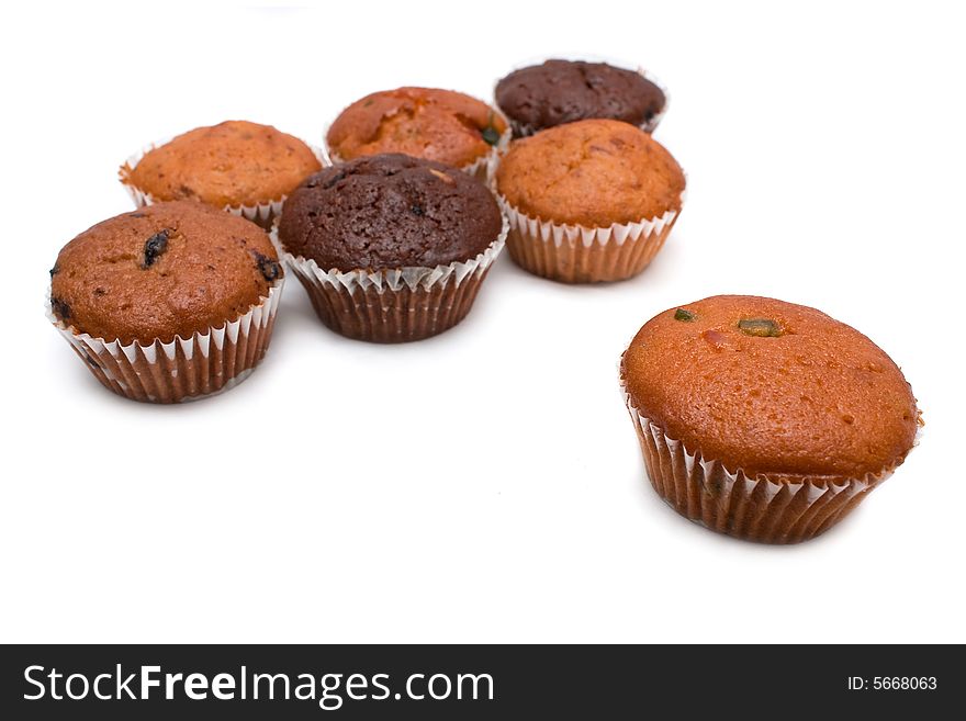 Many muffins put together on white background.