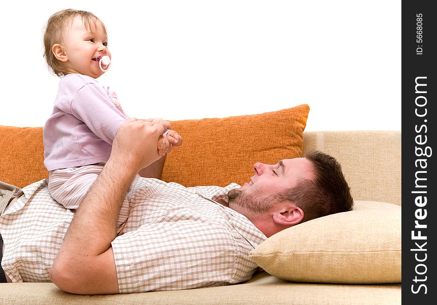 Father and baby girl playing on sofa. Father and baby girl playing on sofa