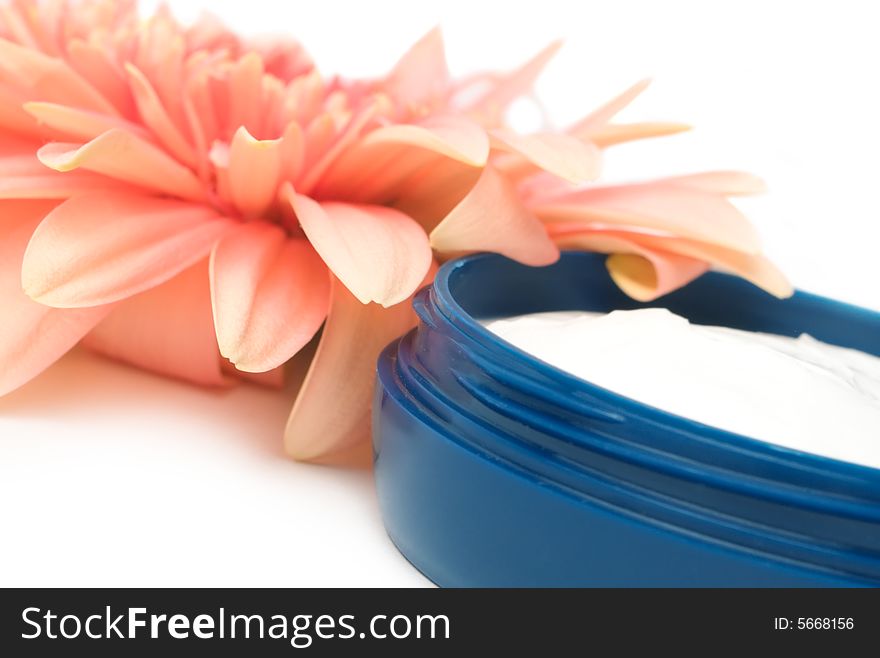 Moisturizing cream with orange gerbera close up