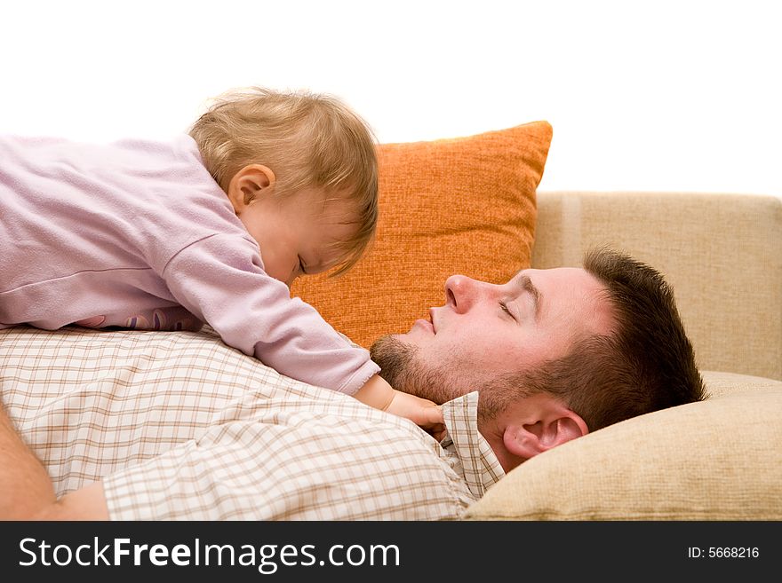 Father and baby girl playing on sofa. Father and baby girl playing on sofa