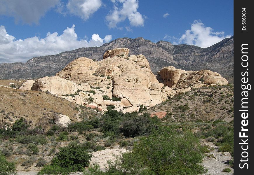 Nature/Park/Outdoors - Red Rock Canyon National Conservation Area Beige rocks forms hills and drak gray mountain in background