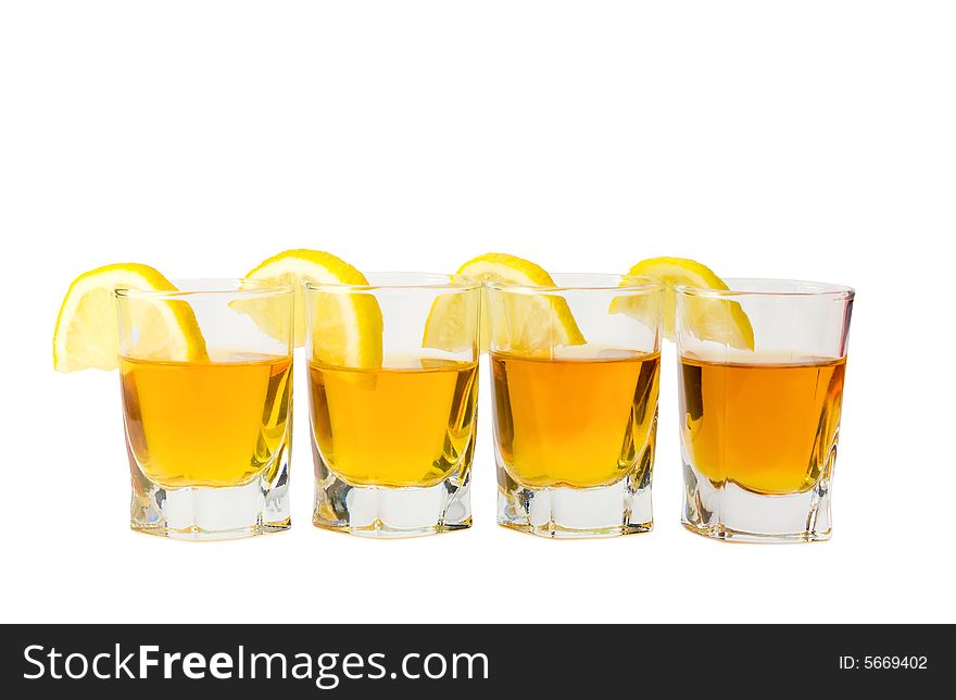 Drink and slices of a fresh lemon isolated on white background. Drink and slices of a fresh lemon isolated on white background.