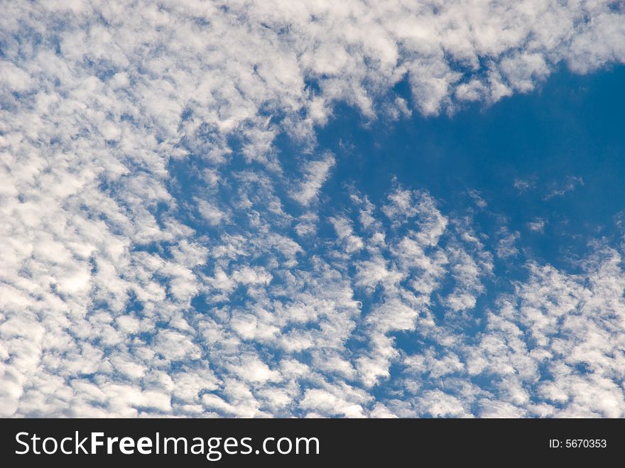 White clouds on a background of the blue sky