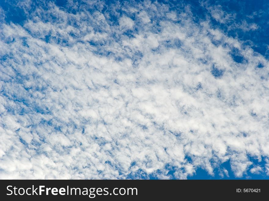 White clouds on a background of the blue sky