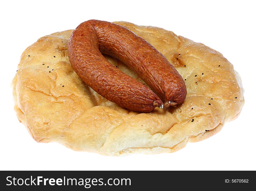 Flat bread with smoked sausage on a white background. Flat bread with smoked sausage on a white background.