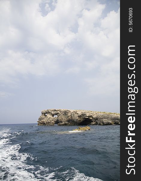 Rock, sea, clouds and blue sky