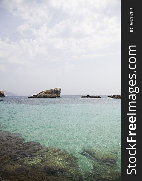 Rock, sea, clouds and blue sky