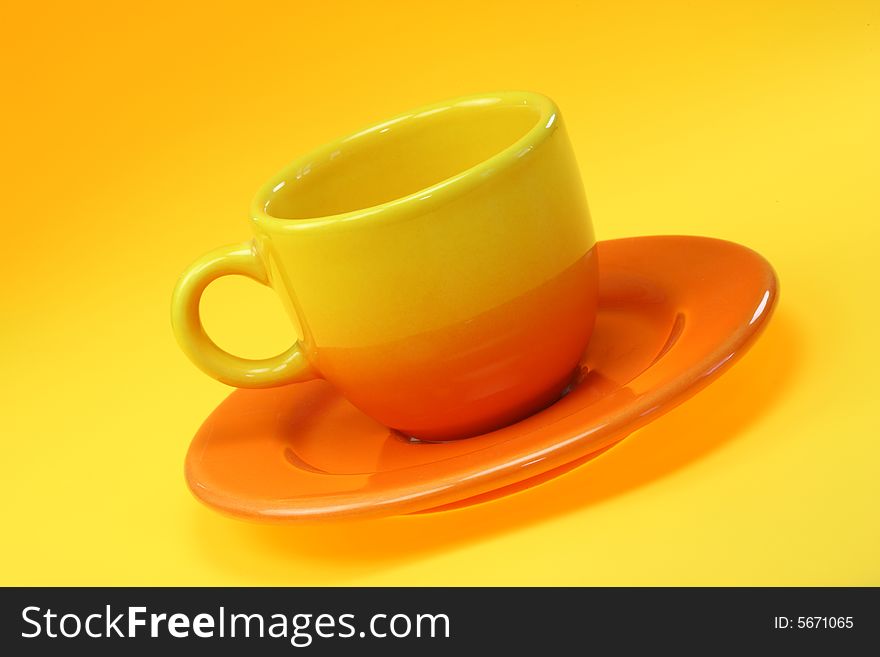 Coffee cup with saucer on a orange background. Coffee cup with saucer on a orange background.