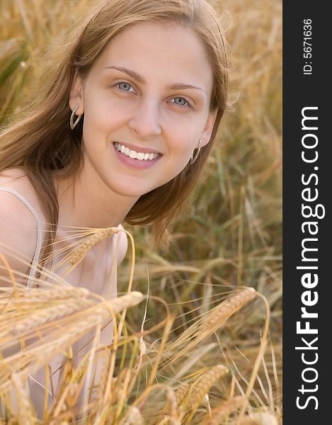 Beautiful young woman laughing on the field background. Beautiful young woman laughing on the field background