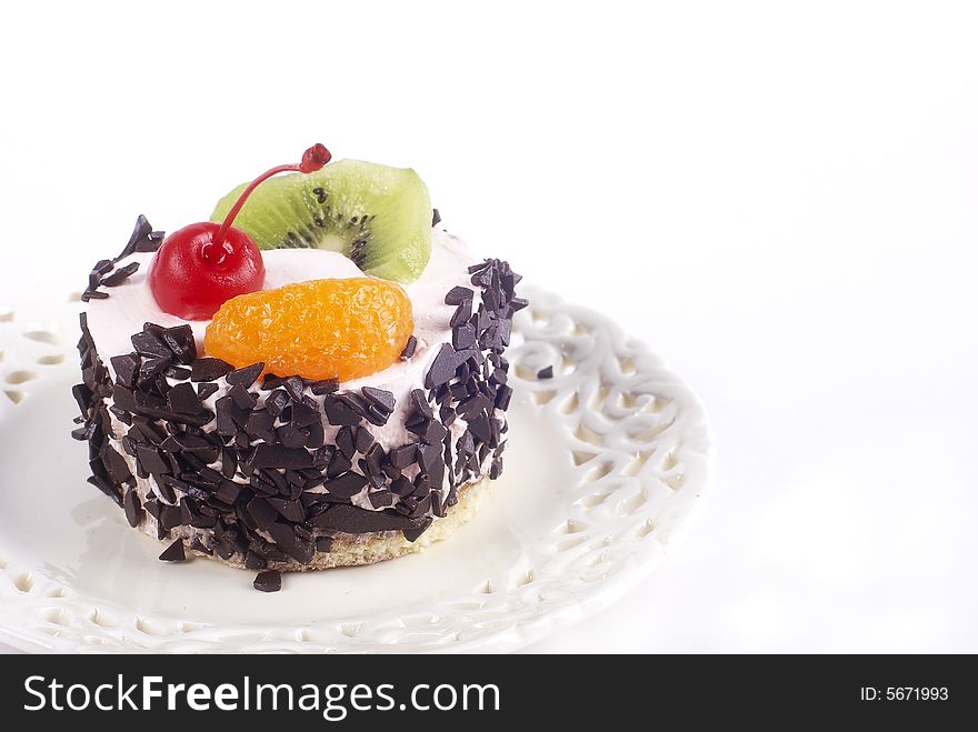 Fruit cake on a plate on a white background. Fruit cake on a plate on a white background