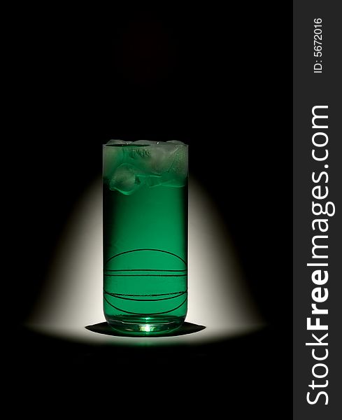 Green mint drink with ice cubes on dark background. Green mint drink with ice cubes on dark background