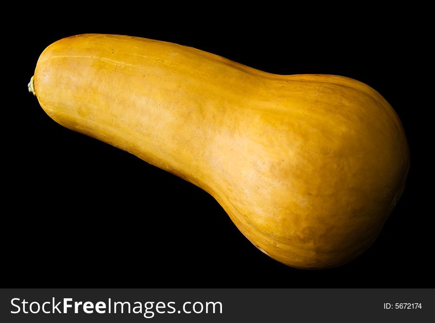 Yellow pumpkin isolated in a black background