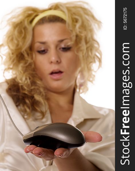 Young blonde woman holding mouse input device, focus on mouse
