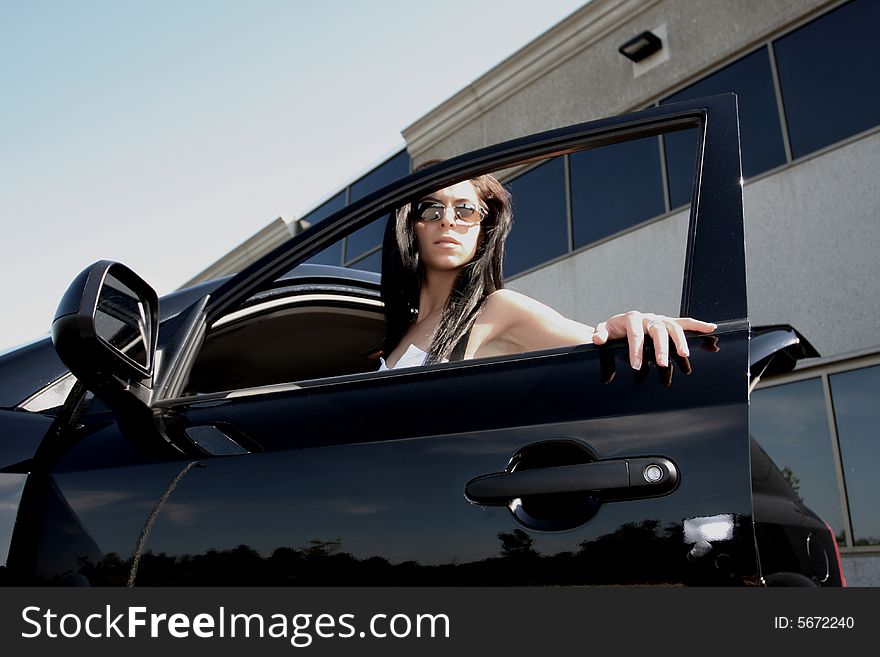 Female fashion model opening a car door. Female fashion model opening a car door