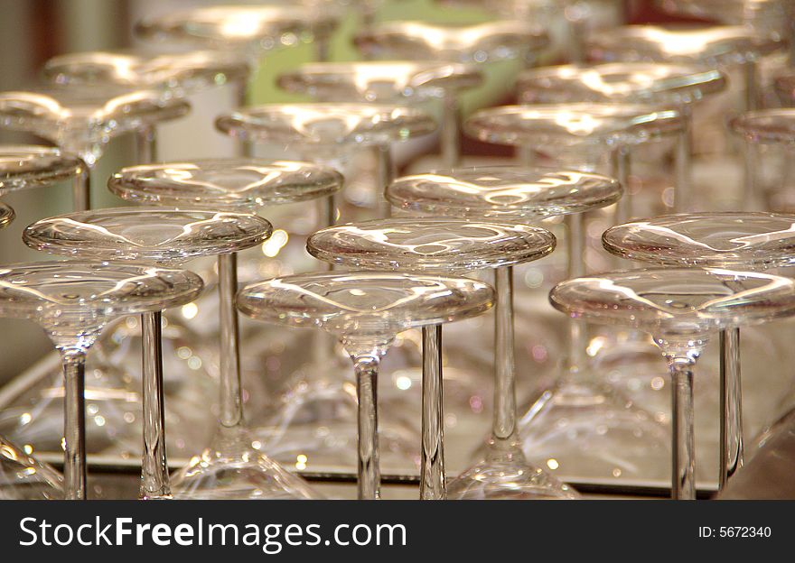 Several rows of upside down wineglasses, shimmering on a bar in a winery (vineyard). Adelaide, South Australia.