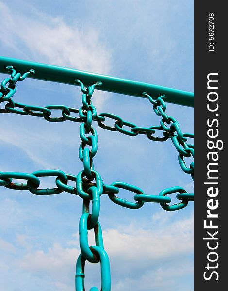 The iron chain of  fitness equipment with a blue sky background in a park .