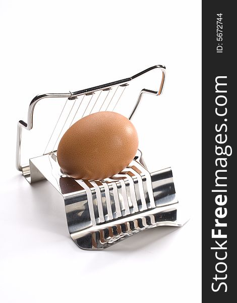 Egg cutter with an egg on white background