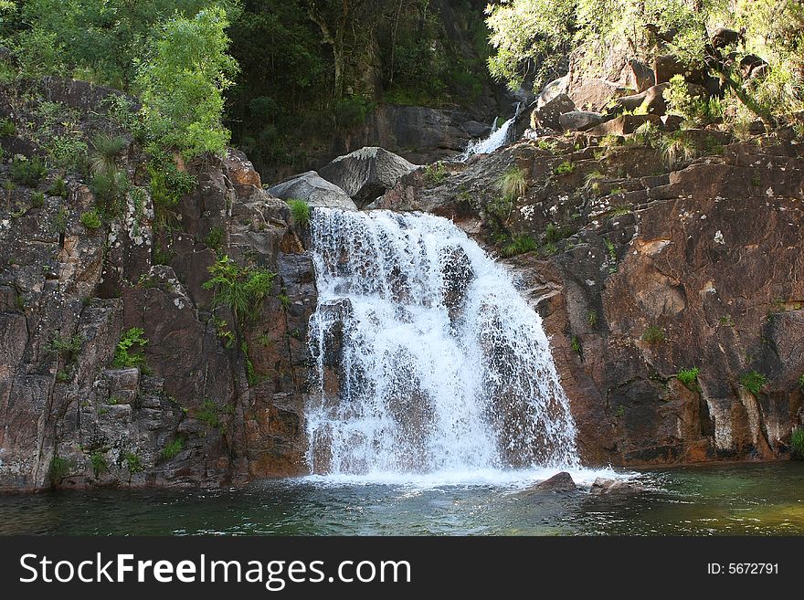 Waterfall with trees and transparent water. Waterfall with trees and transparent water