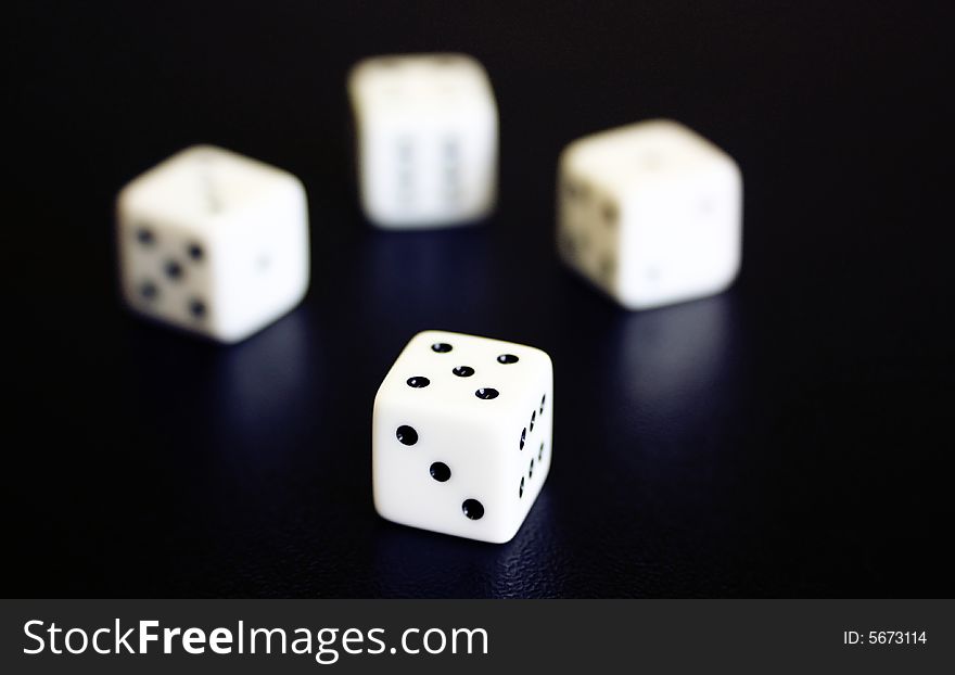 White dices on black background