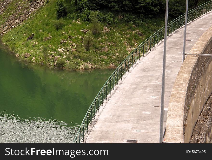 A dam built in the hills near Genoa (Italy) with its lake. A dam built in the hills near Genoa (Italy) with its lake