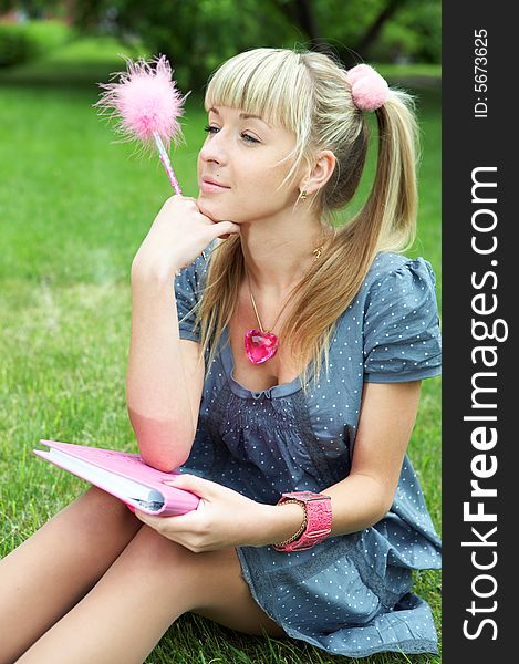 Woman with book on green grass