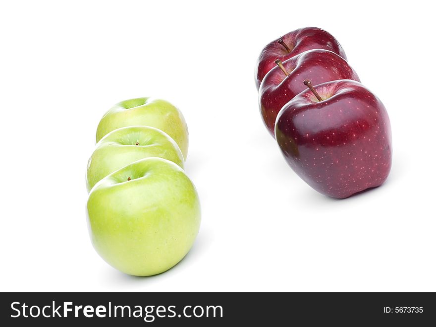 Red and green apples lined up on a white background