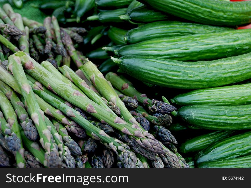 Pile of fresh asparagus and cucumbers. Pile of fresh asparagus and cucumbers.