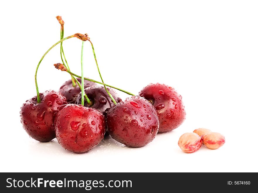 High resolution image of wet, fresh cherries and stones