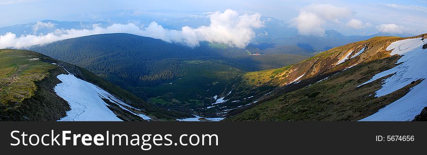 Panoramic photo slightly snowcapped ridge of Carpathian Mountains