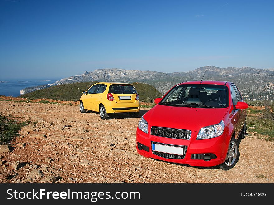 Two small family cars in mountains