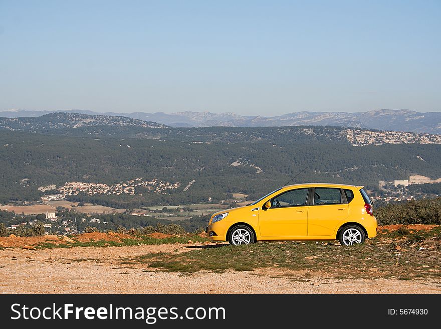 A small family yellow car. A small family yellow car