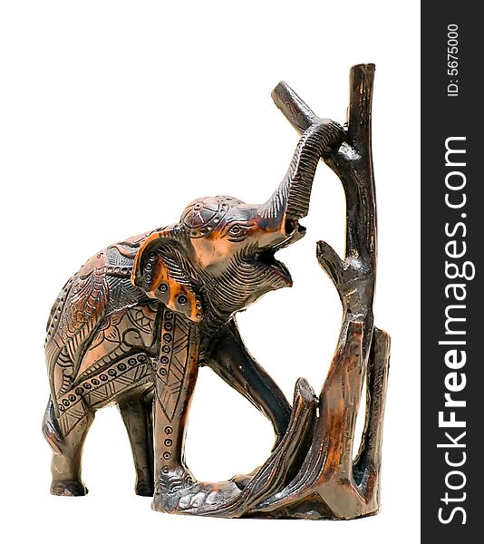 Decorative handmade wooden elephant by a tree. Decorative handmade wooden elephant by a tree.