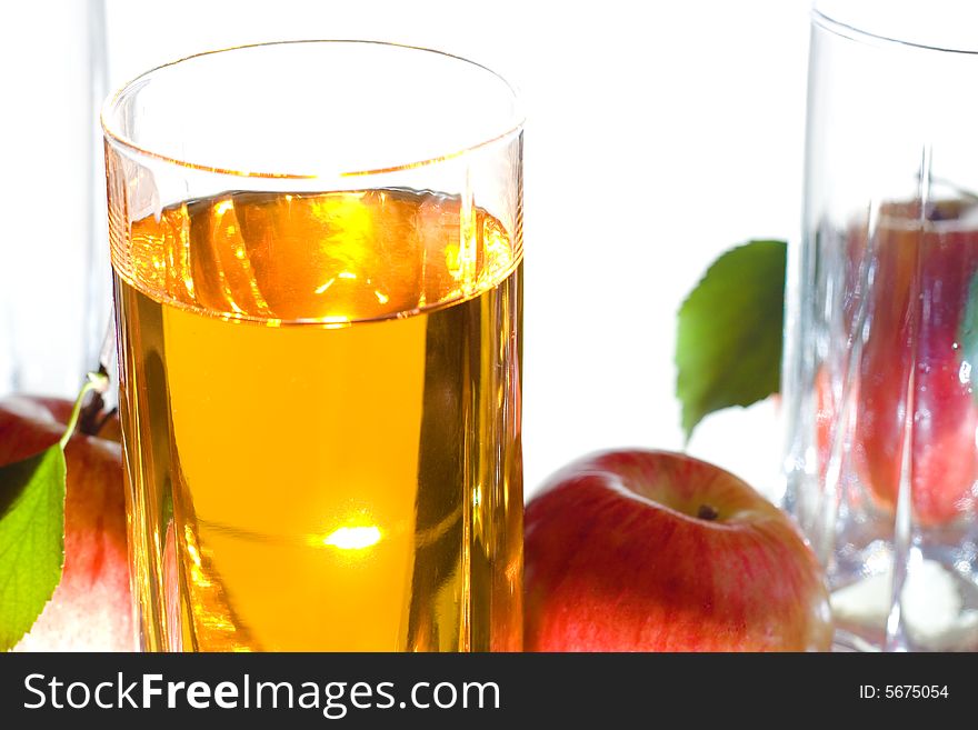 Apples with leaves and juice isolated on white background