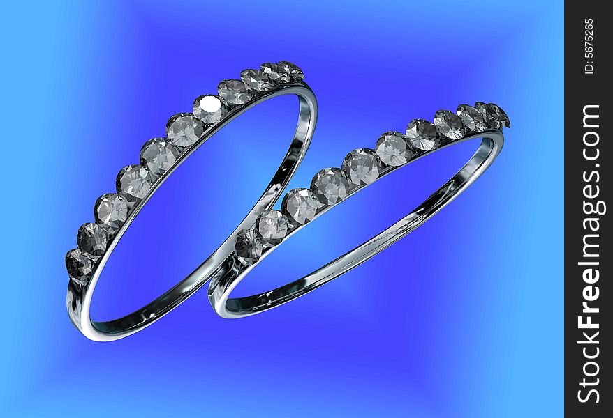 Two rings with diamonds against a colorful background