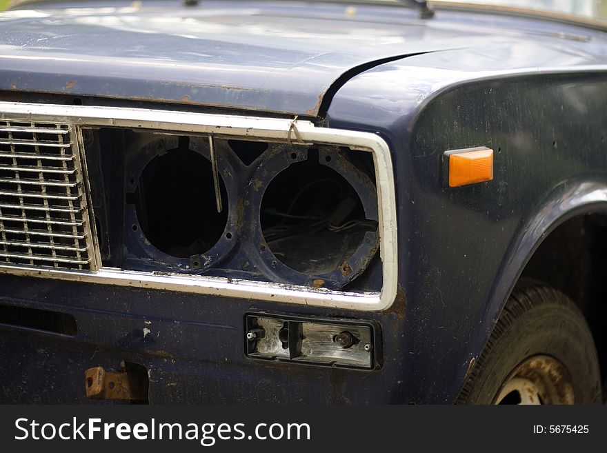 Closeup of old broken car headlight