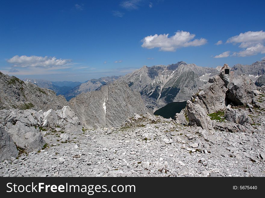 Clouds above the mountains Austrian  Alpes . The snow on the rocks. Sight from the peak of Hafelkarspitze mountain .Not so far from Innsbruck  . Clouds above the mountains Austrian  Alpes . The snow on the rocks. Sight from the peak of Hafelkarspitze mountain .Not so far from Innsbruck  .