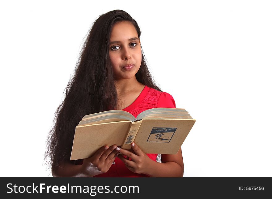 11 year old girl, holding a book close to herself. 11 year old girl, holding a book close to herself