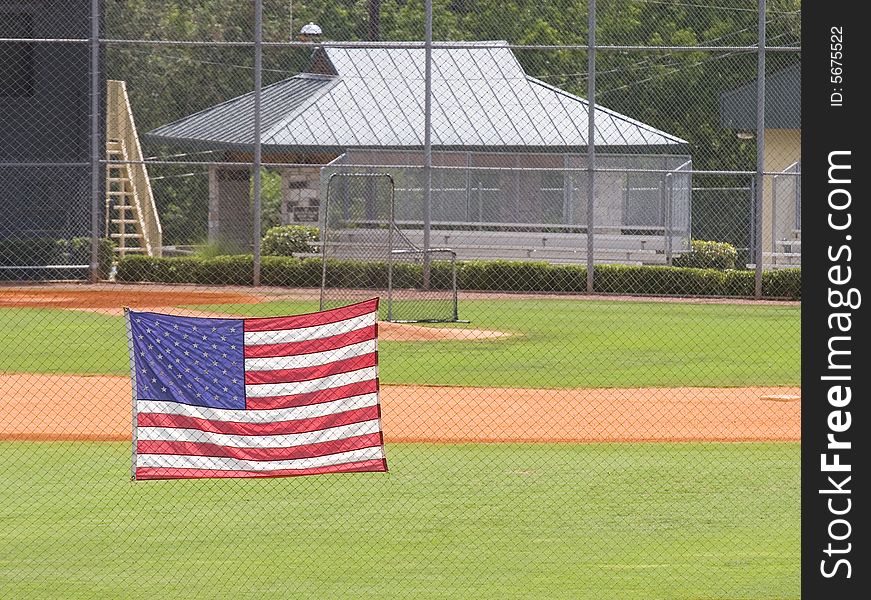 A baseball outfield with american flag in foreground. A baseball outfield with american flag in foreground