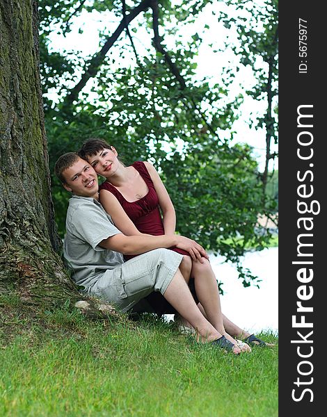 Happy young couple relaxing near the river