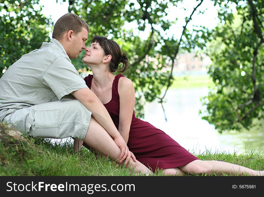 Happy young couple relaxing near the river. Happy young couple relaxing near the river