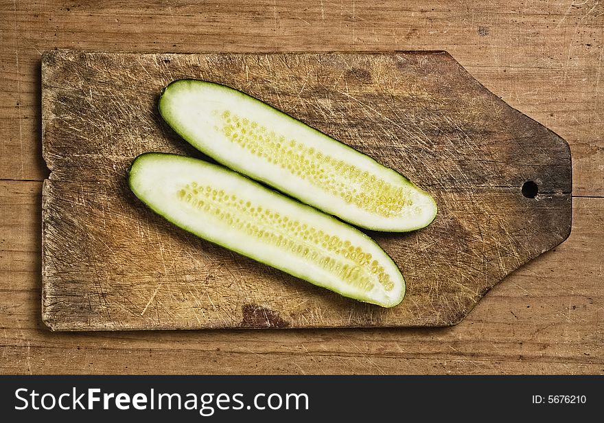 Slices of fresh cucumber on a wooden background.