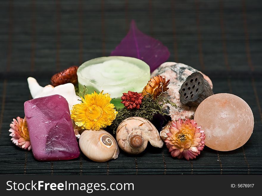 Composition of flowers, sea shells, soaps and rock. Composition of flowers, sea shells, soaps and rock