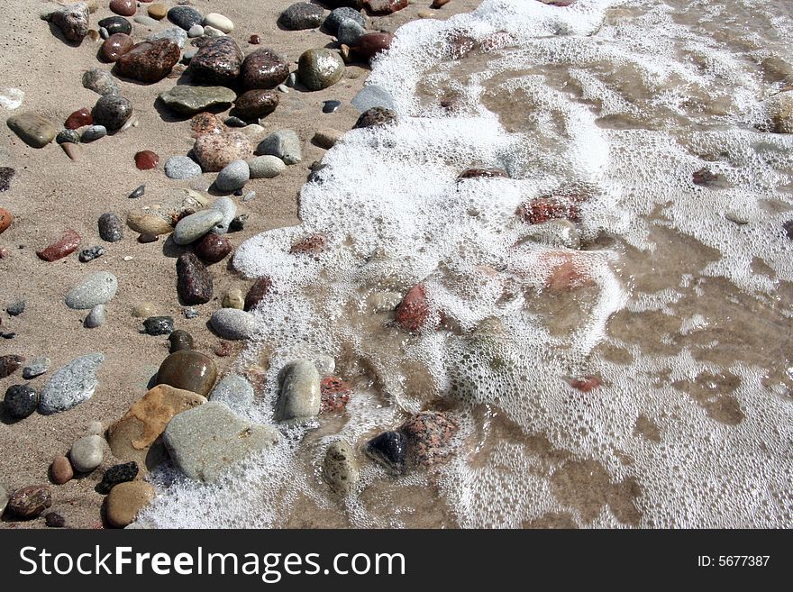 Sea water splashing over stones. Sea water splashing over stones.