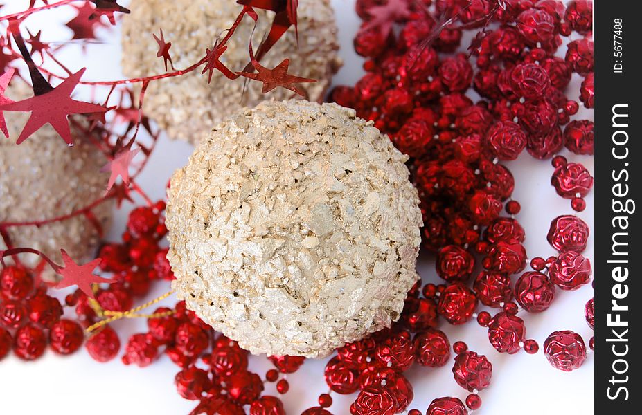 Christmas decorations, shiny gold sphere and red garland