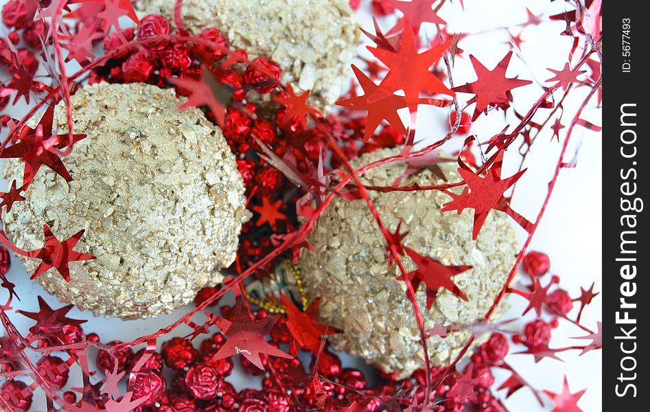 Christmas decorations, shiny gold sphere and red garland