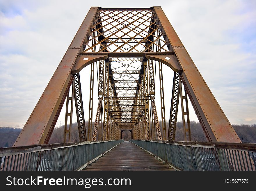 Wide view of pedestrian and cyclist footbridge over reservoir.