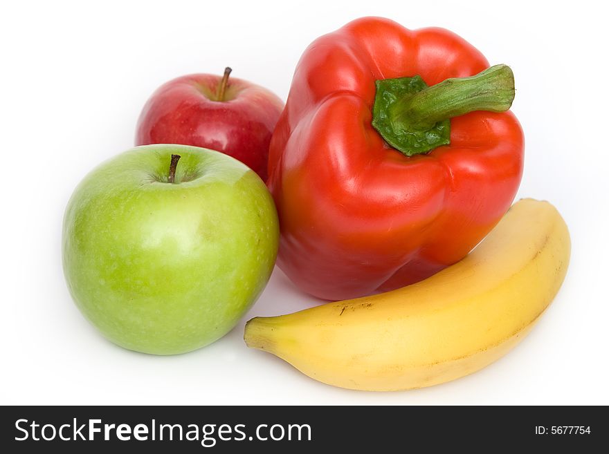 Two apples, banana and red paprika on white background. Two apples, banana and red paprika on white background